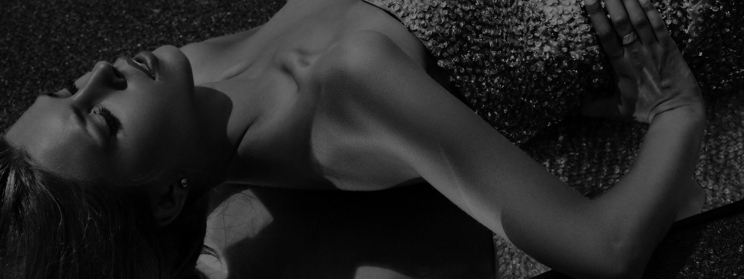 Black and white portrait of a reclining woman.