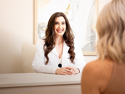 Doctor consulting with patient in office setting.