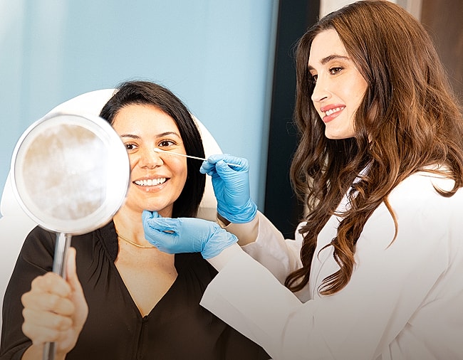 Patient receiving skincare treatment from professional.