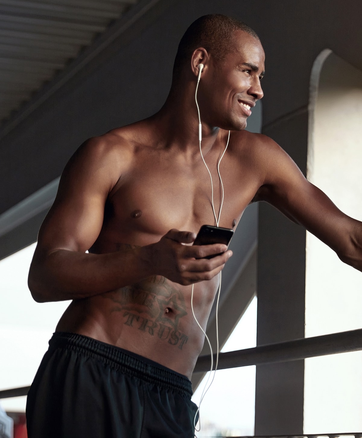 Man listening to music while holding phone.