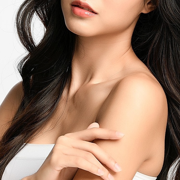 Woman in white athletic outfit, natural light.