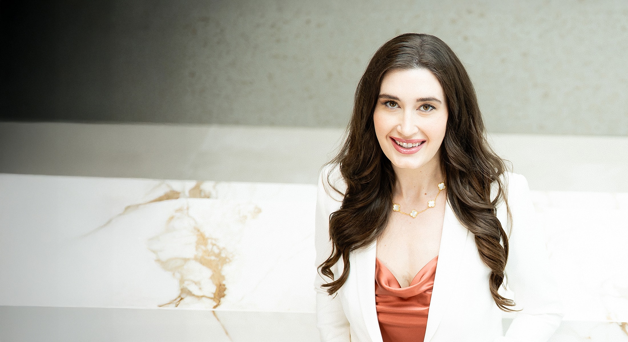 Smiling woman in a stylish outfit indoors.